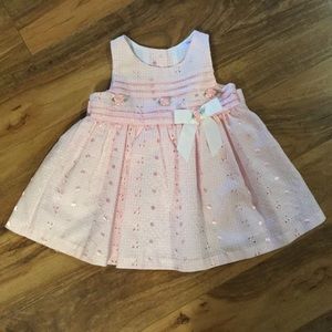 pink dress with embroidery and rosette detail